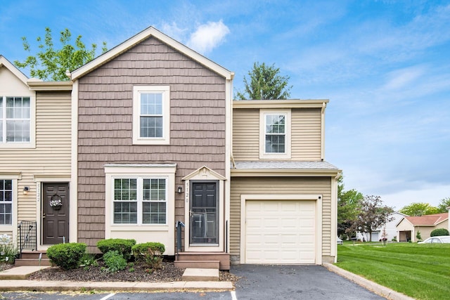 5120 Singleton Dr Unit 36D, Hilliard, OH 43026 - multi unit property featuring asphalt driveway, a front lawn, and a garage