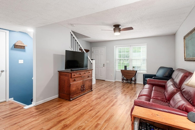 5120 Singleton Dr Unit 36D, Hilliard, OH 43026 - living room featuring stairs, light wood-type flooring, a ceiling fan, a textured ceiling, and baseboards