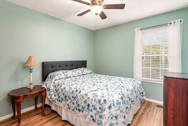 5120 Singleton Dr Unit 36D, Hilliard, OH 43026 - bedroom with wood finished floors, baseboards, a textured ceiling, and ceiling fan