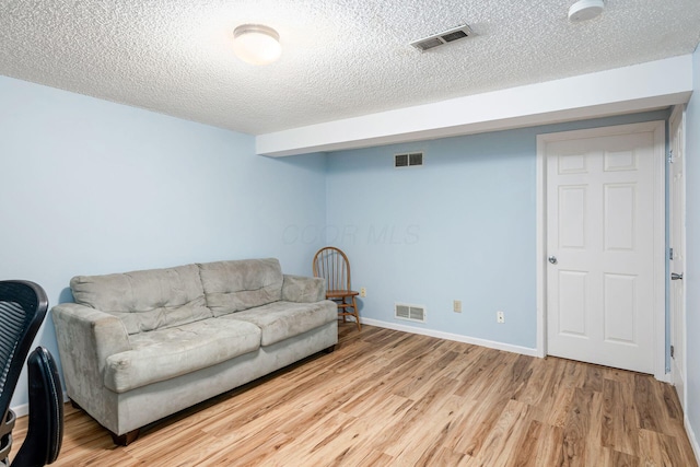 5120 Singleton Dr Unit 36D, Hilliard, OH 43026 - living room with light wood-style floors, a textured ceiling, and baseboards
