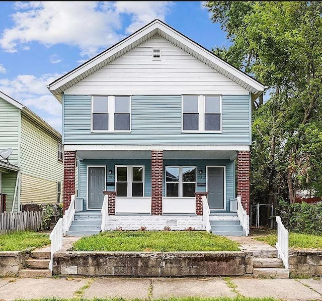 780-782 Gibbard Ave, Columbus, OH 43201 - view of front of home featuring covered porch, fence, and brick siding