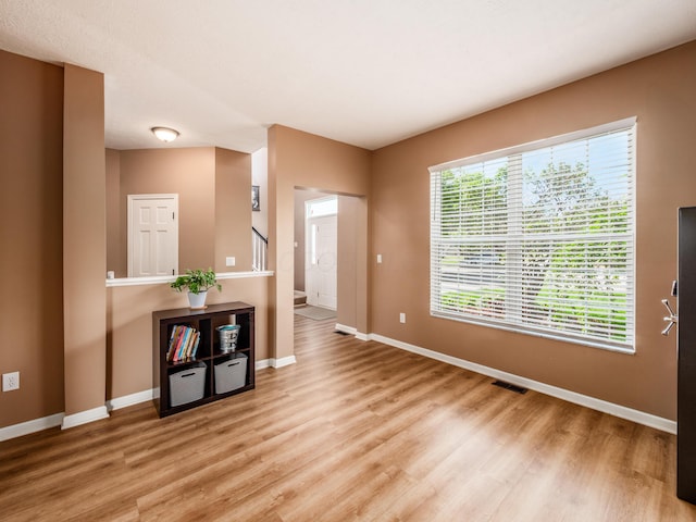4710 Helmsbridge Ct, Grove City, OH 43123 - unfurnished room with baseboards, light wood finished floors, and stairway