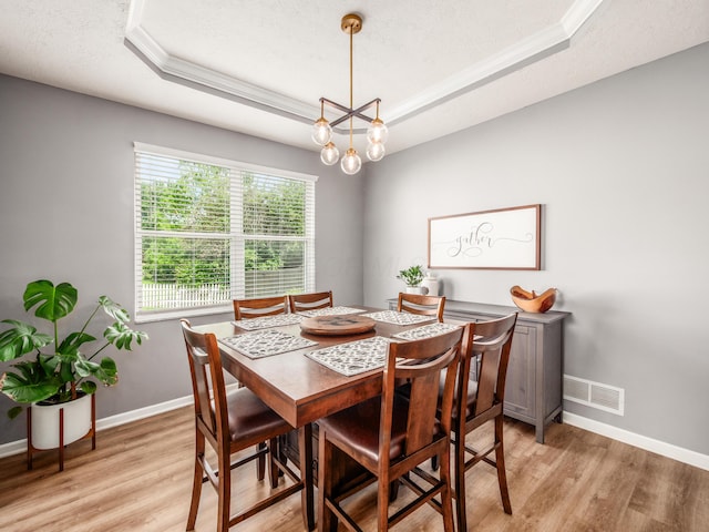 4710 Helmsbridge Ct, Grove City, OH 43123 - dining area with a tray ceiling, light wood-style floors, baseboards, and ornamental molding