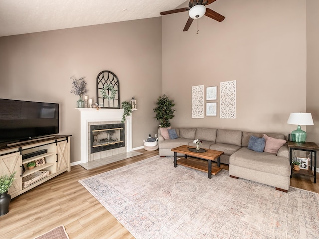 4710 Helmsbridge Ct, Grove City, OH 43123 - living area with ceiling fan, high vaulted ceiling, wood finished floors, a fireplace, and baseboards