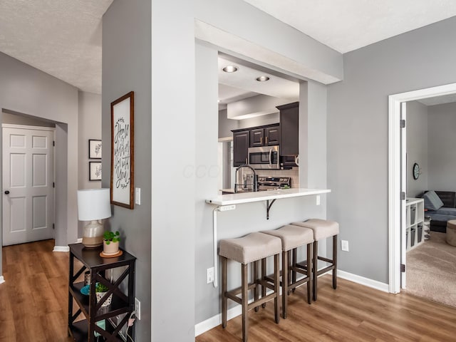 4710 Helmsbridge Ct, Grove City, OH 43123 - corridor featuring wood finished floors, baseboards, and a sink