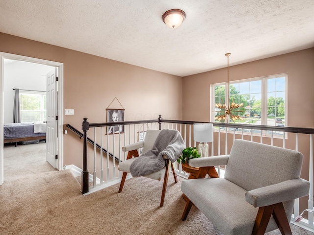 4710 Helmsbridge Ct, Grove City, OH 43123 - living area with carpet, an upstairs landing, a textured ceiling, and baseboards