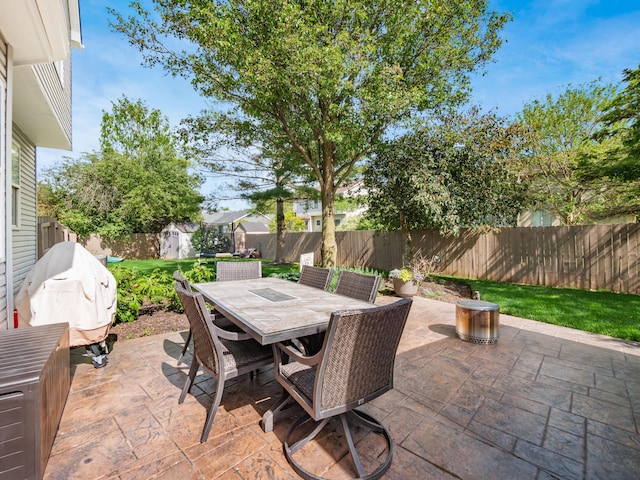 4710 Helmsbridge Ct, Grove City, OH 43123 - view of patio / terrace featuring a storage unit, a fenced backyard, outdoor dining space, and an outbuilding