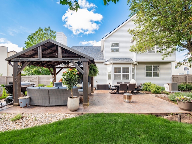 4710 Helmsbridge Ct, Grove City, OH 43123 - back of house with an outdoor living space, a gazebo, a chimney, roof with shingles, and a patio