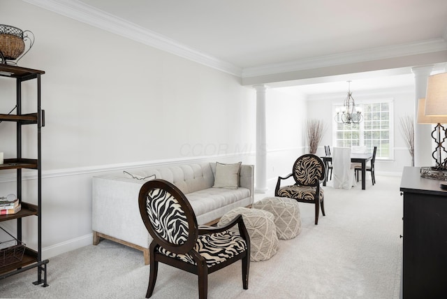 sitting room featuring carpet, decorative columns, a chandelier, crown molding, and baseboards