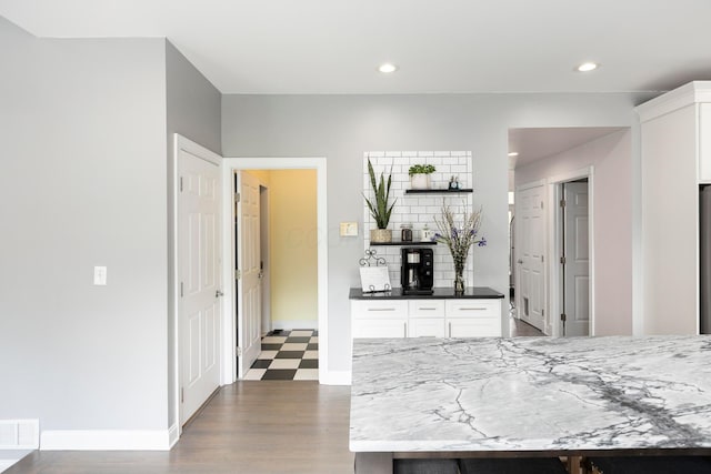 kitchen with white cabinetry, recessed lighting, baseboards, dark wood finished floors, and decorative backsplash