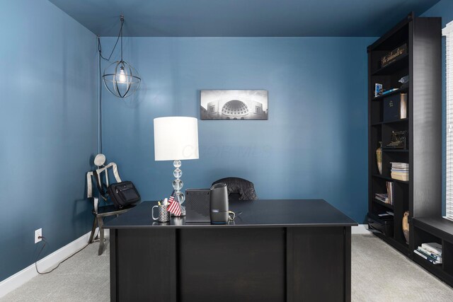 office space with light carpet and baseboards