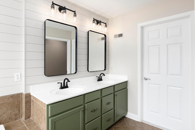 full bath with double vanity and tile patterned flooring