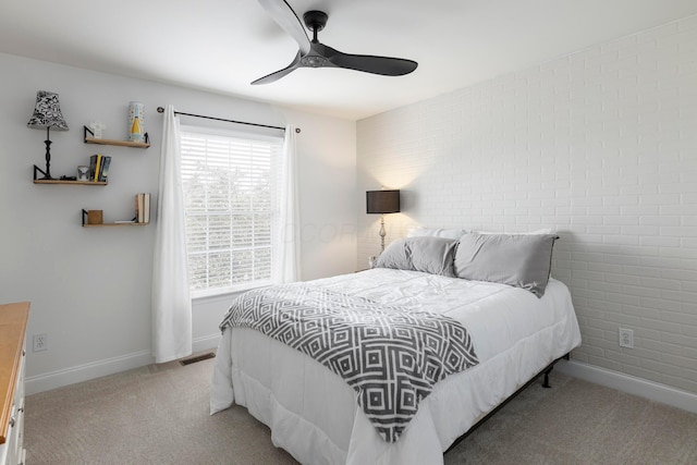 carpeted bedroom with baseboards and ceiling fan