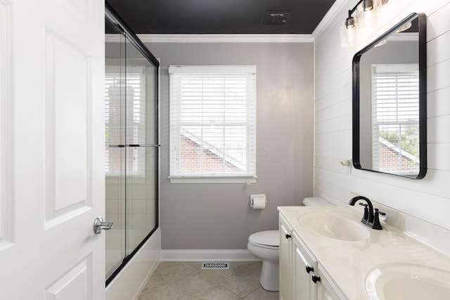 full bathroom with ornamental molding, toilet, double vanity, tile patterned floors, and baseboards
