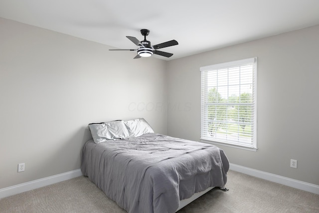 bedroom with baseboards, light carpet, and ceiling fan