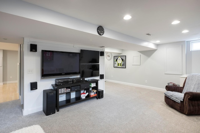 carpeted living area featuring baseboards and recessed lighting