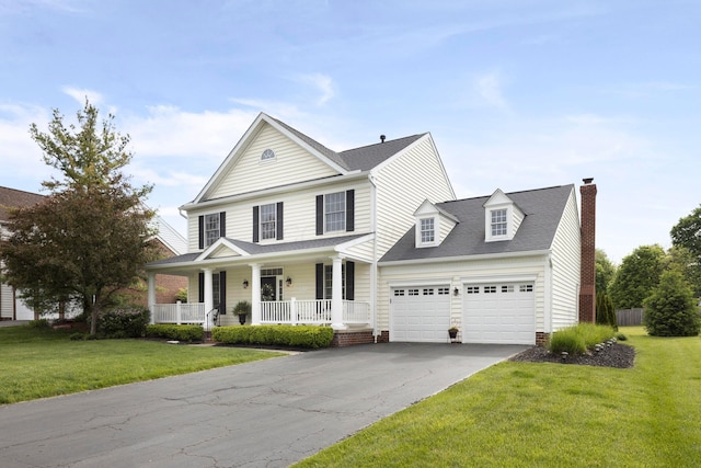 view of front of home with covered porch, an attached garage, driveway, a chimney, and a front lawn
