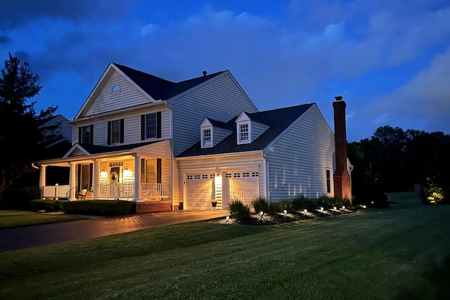 view of front of home with a porch, a chimney, a front lawn, concrete driveway, and an attached garage