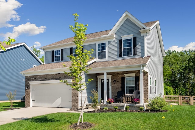 249 Rochdale, Delaware, OH 43015 - view of front of home with covered porch, driveway, an attached garage, brick siding, and a shingled roof
