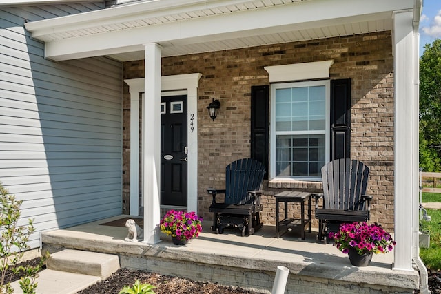 249 Rochdale, Delaware, OH 43015 - view of exterior entry featuring brick siding and a porch