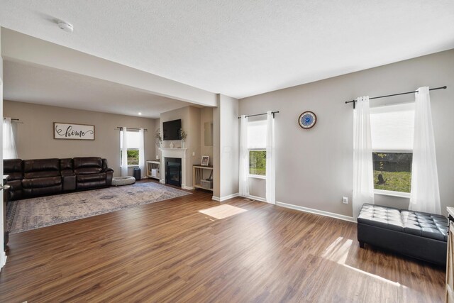 249 Rochdale, Delaware, OH 43015 - living area with wood finished floors, plenty of natural light, a glass covered fireplace, and baseboards