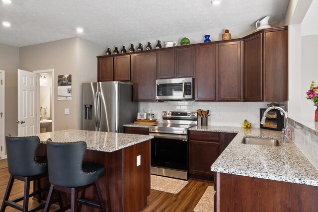 249 Rochdale, Delaware, OH 43015 - kitchen with appliances with stainless steel finishes, a sink, dark wood finished floors, backsplash, and a kitchen island