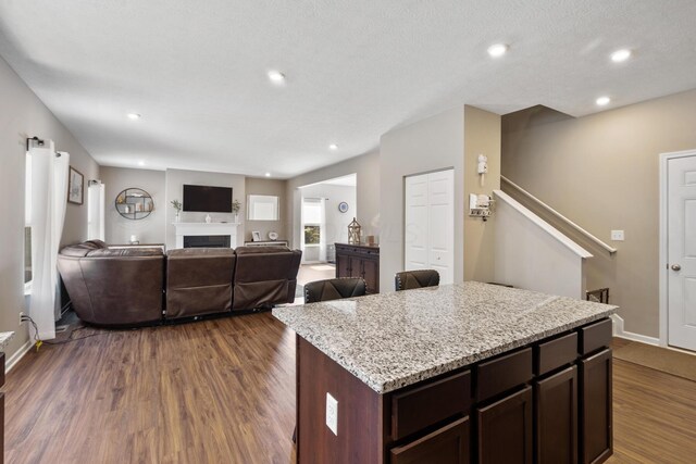 249 Rochdale, Delaware, OH 43015 - kitchen featuring dark wood-style floors, dark brown cabinetry, baseboards, a fireplace, and recessed lighting