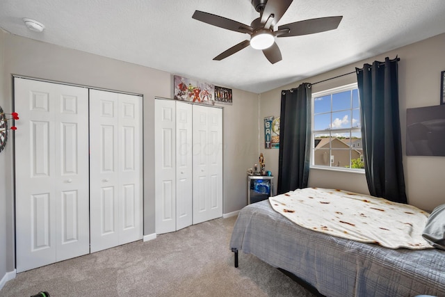 249 Rochdale, Delaware, OH 43015 - carpeted bedroom featuring two closets, a ceiling fan, baseboards, and a textured ceiling