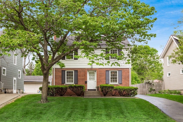 view of front of home with brick siding, entry steps, and driveway