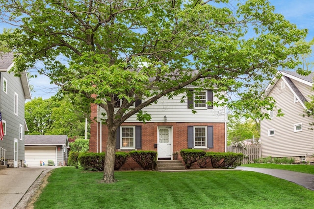 view of front of house featuring brick siding, an outbuilding, and a detached garage