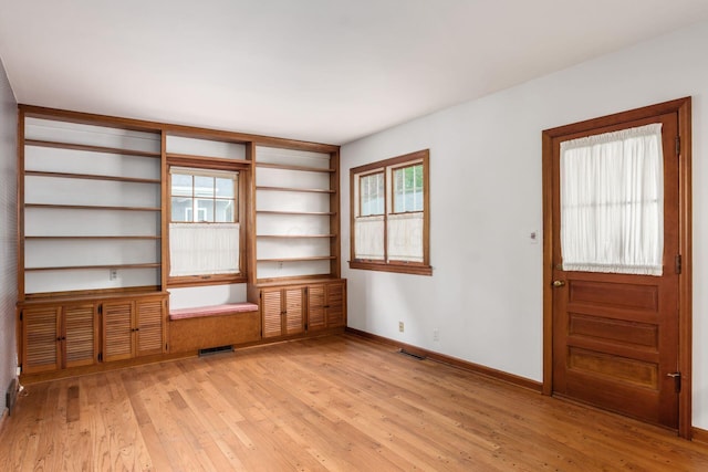 spare room with light wood finished floors and baseboards