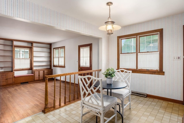 dining room with wallpapered walls and baseboards