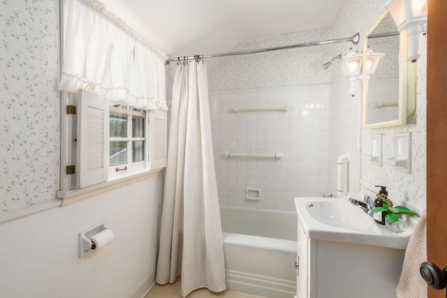 bathroom featuring wallpapered walls, vanity, and shower / bath combo