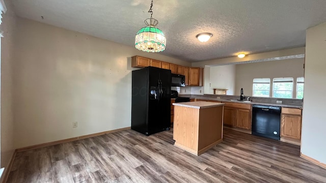 5332 Wadley Ct, Canal Winchester, OH 43110 - kitchen with black appliances, a textured ceiling, dark wood-style floors, a sink, and a center island