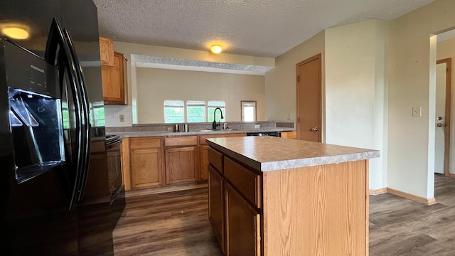 5332 Wadley Ct, Canal Winchester, OH 43110 - kitchen featuring black refrigerator with ice dispenser, dark wood-style flooring, a sink, light countertops, and a center island