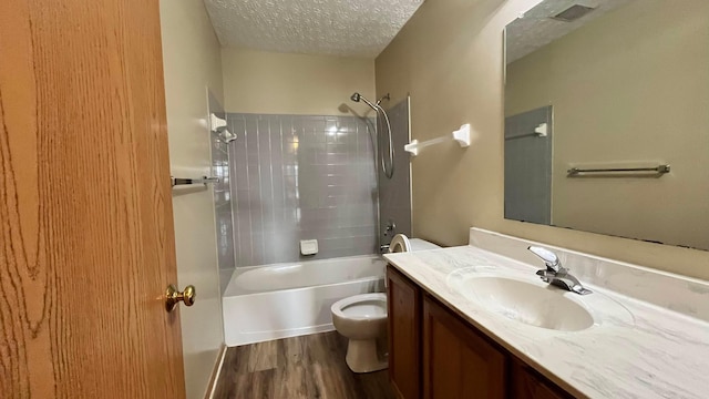 5332 Wadley Ct, Canal Winchester, OH 43110 - full bathroom featuring toilet, wood finished floors, a textured ceiling, vanity, and tub / shower combination
