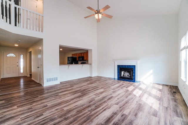5332 Wadley Ct, Canal Winchester, OH 43110 - unfurnished living room with high vaulted ceiling, wood finished floors, ceiling fan, and a tiled fireplace
