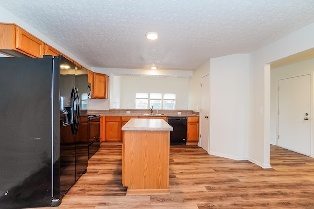 5332 Wadley Ct, Canal Winchester, OH 43110 - kitchen with black appliances, a textured ceiling, light wood-type flooring, light countertops, and recessed lighting