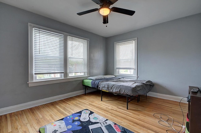 1306-1308 Wilson Ave, Columbus, OH 43206 - bedroom featuring multiple windows, baseboards, wood finished floors, and a ceiling fan