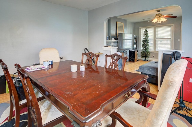 1306-1308 Wilson Ave, Columbus, OH 43206 - dining space with arched walkways, ceiling fan, and wood finished floors