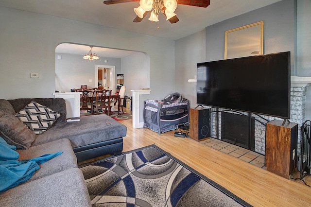 1306-1308 Wilson Ave, Columbus, OH 43206 - living area with arched walkways, ceiling fan, wood finished floors, and a fireplace