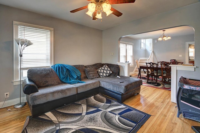 1306-1308 Wilson Ave, Columbus, OH 43206 - living room featuring arched walkways, light wood finished floors, ceiling fan, and a chandelier