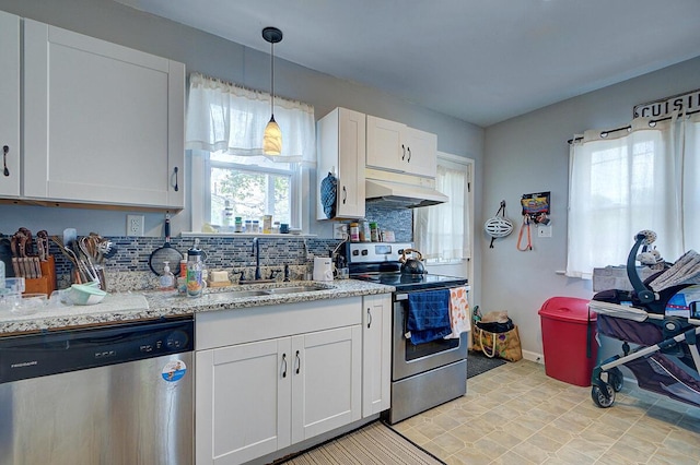 1306-1308 Wilson Ave, Columbus, OH 43206 - kitchen featuring stainless steel appliances, under cabinet range hood, healthy amount of natural light, and decorative backsplash