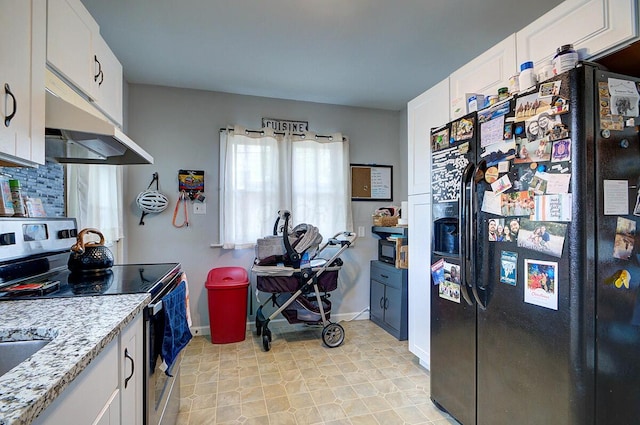 1306-1308 Wilson Ave, Columbus, OH 43206 - kitchen with black fridge, stainless steel electric stove, under cabinet range hood, white cabinets, and baseboards