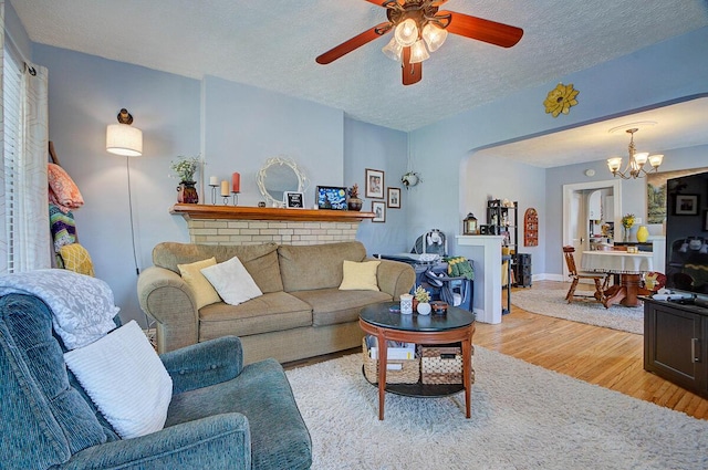 1306-1308 Wilson Ave, Columbus, OH 43206 - living room featuring a chandelier, ceiling fan, wood finished floors, a textured ceiling, and baseboards