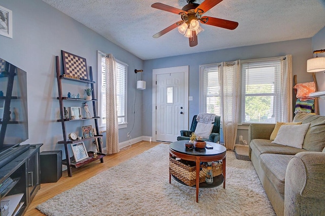 1306-1308 Wilson Ave, Columbus, OH 43206 - living room featuring ceiling fan, light wood finished floors, a textured ceiling, and baseboards
