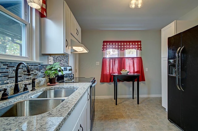 1306-1308 Wilson Ave, Columbus, OH 43206 - kitchen with black refrigerator with ice dispenser, under cabinet range hood, a sink, range with electric stovetop, and tasteful backsplash