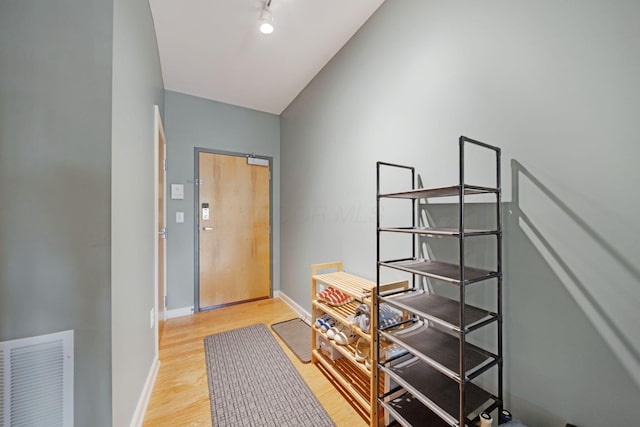 foyer with light wood-type flooring and baseboards