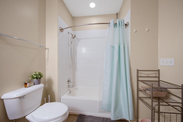 full bath with toilet and shower / bath combo