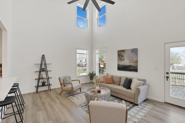 3907 Winding Path Dr, Canal Winchester, OH 43110 - living area featuring a ceiling fan, light wood-style floors, a high ceiling, and baseboards